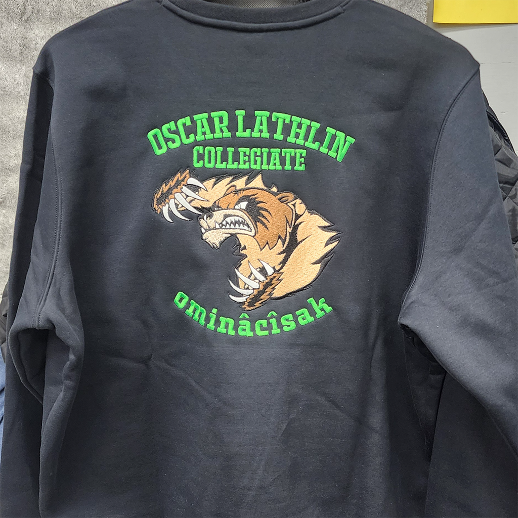 "Oscar Lathin Collegiate – ominâcîsak" with a wolverine embroidered school sweatshirt